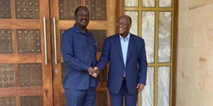 Former Prime Minister Raila Odinga (left) greets the late Tanzanian President John Magufuli