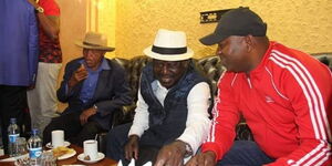Former Prime Minister Raila Odinga (second right) and former Sports CS Rashid Echesa at a past function.