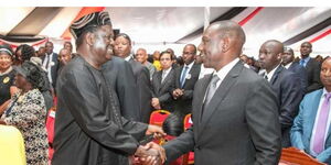 Former Prime Minister Raila Odinga greets President William Ruto during the funeral of musician Joseph Kamaru in October 2018. 