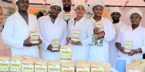 From left, Charles Wachira with some members of G-Star Youth Group display the porridge flour they ake using bananas. 
