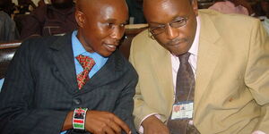 Ganze MP Teddy Mwambire speaks to the Clerk to the Council Mr Leboo Ole Morintat in Kilifi County hall.