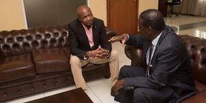 Gatundu South MP Moses Kuria with Opposition leader Raila Odinga at the ODM leader's Capitol Hill office in Nairobi on March 26, 2018.
