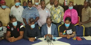 George Koimburi (center), Juja by-election candidate under the  People's Empowerment Party, addresses a press conference in Ruiru.