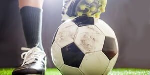 Stock image of a footballer stepping on a ball