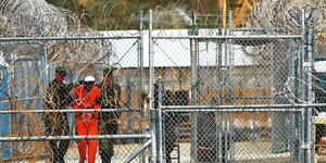 File photo of a prisoner being moved from a military detention center in the US accompanied by soldiers