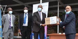 Health CAS Rashid Aman (Second from Right) receiving the medical donation from a Fosun Pharma representative outside Afya House on August 25, 2020.