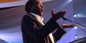 Political analyst Herman Manyora gestures while delivering an address at a past event