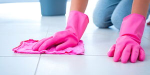 A file image of a house keeper moping a floor