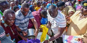 ICT CS Eliud Owalo leads other leaders in distributing food in Siaya