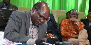 IEBC Chairman Wafula Chebukati  signs a document at the Bomas of Kenya on Monday, June 6, 2022.