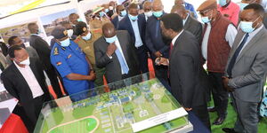 Inspector General of Police Hillary Mutyambai (in Blue) and other leaders look at an artistic impression of the Police Academy in Ngong