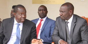 Interior Cabinet Secretary Dr Fred Mitiangi (left) speaks to Deputy William Ruto (right) at a past function.