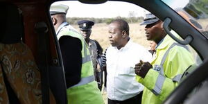 Interior CS Fred Matiang'i interacts with Police officers during a past traffic crackdown