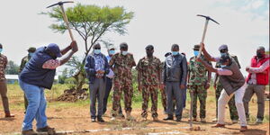 Interior CS Fred Matiang'i (left) takes part in construction of a house in Laikipia on Saturday, September 11, 2021.