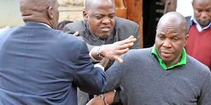 James Muhati (in grey sweater) is accosted by relatives of the late IEBC ICT manager Chris Msando at City Mortuary, Nairobi on  August 1, 2017