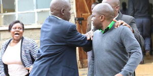 A security officer protects IEBC ICT Director James Muhati after he was accosted by relatives of the late IEBC ICT Manager Chris Msando at City Mortuary in Nairobi on  31 July 2017