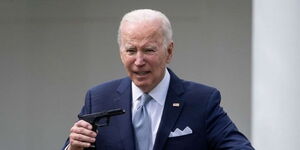 US President Joe Biden Holding a makeshift gun while announcing new guidelines for firearm holders