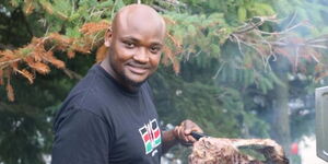 A photo of Kenyan chef John Mulwa preparing roasted meat in Canada.