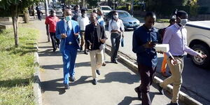 Journalists escort two fellow reporters to DCI offices in Nakuru County on April 9, 2020.