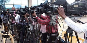 Journalists docked at a media center while covering an event.