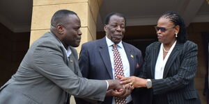 KBC Veteran Lenard Mambo Mbotela (center) with Chief Justice Martha Koome (right) and a guest during his swearing in on Monday, September 26, 2022.