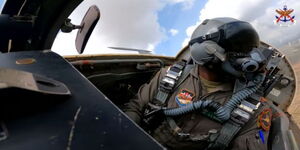 A Kenya Air Force Soldier flies a jet.