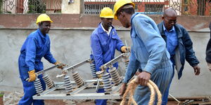 File image of Kenya Power and Lighting (KPLC) officers carrying a transformer.
