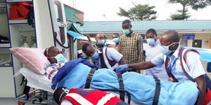 Kabuchai MP James Lusweti Mukwewith AMREF medics and Webuye West MP Dan Wanyama (in chequered shirt) and Bungoma Senator Moses Wetangula (second right) at Wilson Airport on Thursday, April 16