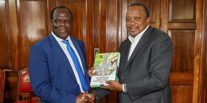 Kakamega Governor Wycliffe Oparanya (l) hands President Uhuru Kenyatta the Sugarcane Taskforce Report on February 24 at State House Nairobi..jpg