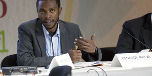 Kennedy Mbeva Liti speaking at a conference.