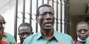 Kenya National Union of Teachers (KNUT) Collins Oyuu speaking at a past event alongside other KNUT officials