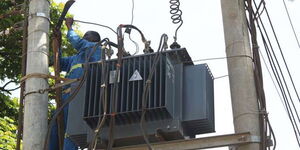 Kenya Power workers repair a transformer on the Meru-Makutano road on March 28, 2016.