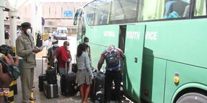 Kenyans board a National Youth Service bus headed to a government quarantine facility on March 24, 2020. 