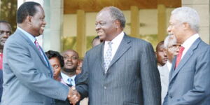 Former President, Mwai Kibaki, and former Prime Minister, Raila Odinga, shake hands as a sign of peace in January 2008 leading to the formation of the Grand Coalition Government. Looking on is former UN Secretary General, Kofi Annan (right), and former Gichugu MP, Martha Karua (back).