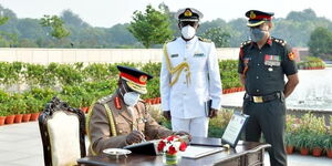 Kenya's Chief of Defence Forces General Robert Kibochi signs the visitors' book at the Military College of Telecommunications Engineering on November 10, 2020