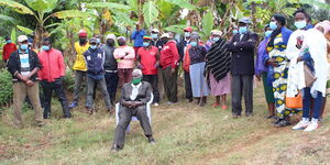 Thomas Mwaga (center), who is over 100-years-old and a survivor of a botched kidnapping in Murang'a County.