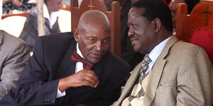 Prime Minister Raila Odinga (right) shares a word with former Member of Parliament Kimani Wanyoike at Gatuanabu Presbyterian Church of East Africa in Kiambu on August 07, 2011. 