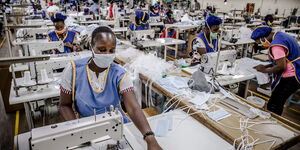 Workers at the Kitui County Textile Centre (KICOTEC) sew surgical masks on Wednesday, April 8, 2020.