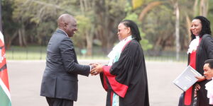 President William Ruto shakes hands with Chief Justice Martha Koome during the swearing-in of judges at State House on September 14, 2022.