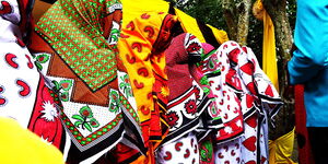 Ladies hide their faces as groom tries to identify lover during a past ruracio ceremony.