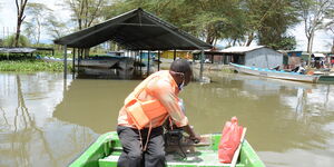 A boat operator assesses damage at Lake Naivasha's Kamere landing beach in May 2020