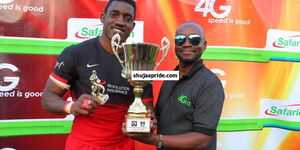Lameck Dunde (left) poses with a trophy after winning the second edition of the Kabeberi Sevens at the RFUEA grounds on August 14, 2016. 