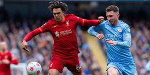 Liverpool full-back Trent Alexander-Arnold (left) and Man City centre back Aymeric Laporte (right) battle for the ball in a past clash. 