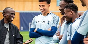 London Marathon champion Eluid Kipchoge (left) interacts with Tottenham Hotspur players during a visit to the football club.