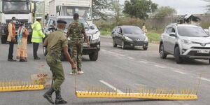 Police officers manning a roadblock on a highway in 2022.