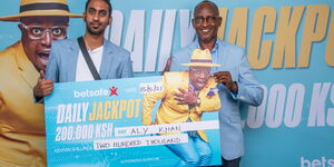 Aly Khan presented with check after winning Ksh200,000 first ever daily jackpot