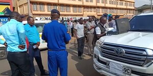 Police and onlookers inspecting the vehicle of Mt Elgon Member of Parliament Fred Kapondi on August 10, 2023.
