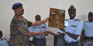 Nairobi Metropolitan Services (NMS) Director-General Maj-Gen Mohamed Abdalla Badi presents a gift to the outgoing KAF Commander Maj Gen Joff Otieno in July 2014