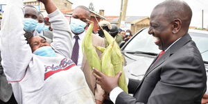 Elizabeth Mueni selling maize to deputy president William Ruto on Wednesday, July 21, 2021. 