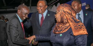 Marathoner Eliud Kipchoge (left), President Uhuru Kenyatta (center) and his Tanzanian counterpart Suluhu Hassan at Glasgow Conference in Scotland on Tuesday, November 2, 2021.